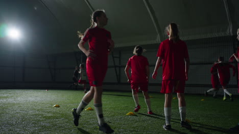 young girls soccer team training indoors