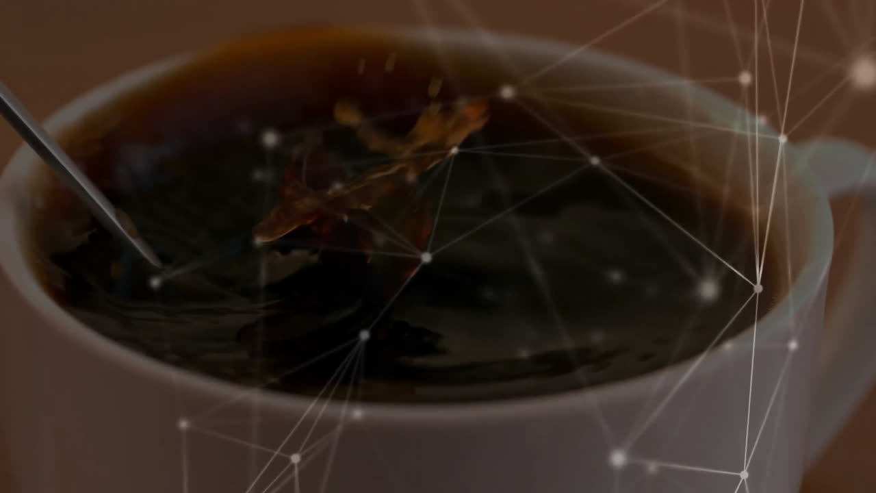 Dark coffee being stirred in ceramic cup by spoon, with glowing nodes and lines overlaying scene