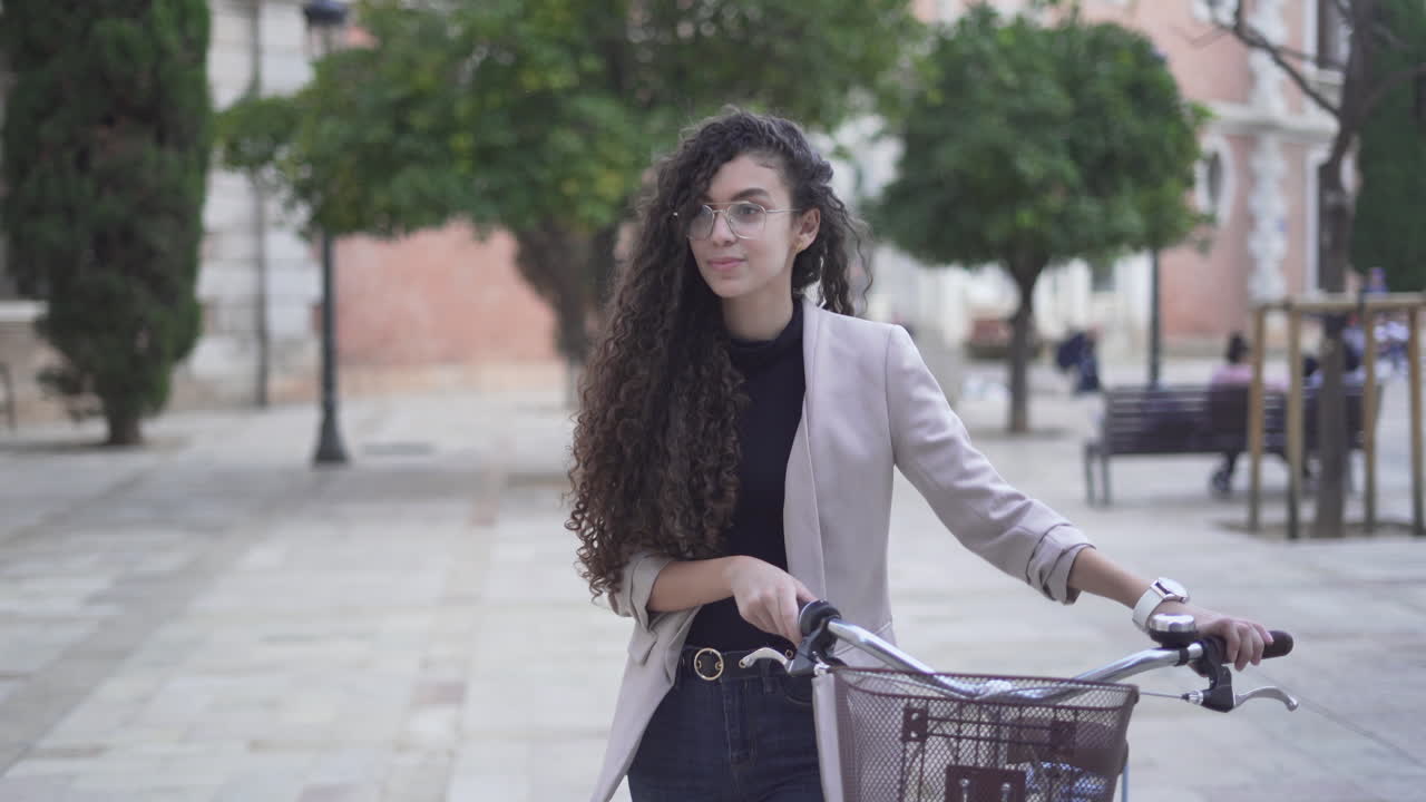 Young woman walking with bicycle in the city