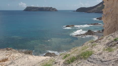 High-angle-of-Porto-dos-Frades-coast-with-rocky-islet-in-background,-Portugal