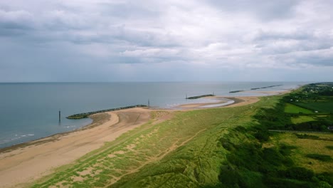 Aerial-landscape-flying-over-a-beach-with-sea-defences-on-the-coast-of-Britain