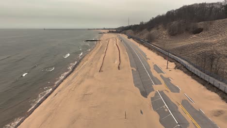 high aerial, forward motion over the wet sand