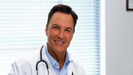 Portrait-of-doctor-sitting-in-hospital