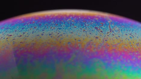 macro photography of a soap bubble with rainbow colors