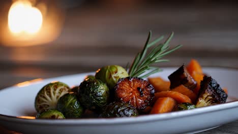 close-up video of a gourmet dish with roasted vegetables, shot at a low angle