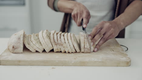 Bread,-knife-and-closeup-of-hands-in-kitchen