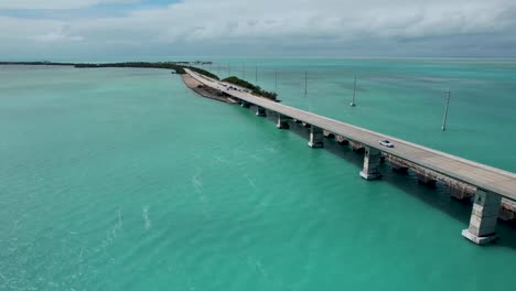 over seas highway florida keys bridge, aerial panning view with blue water