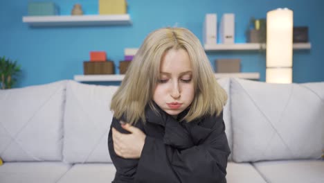 young woman cold at home.