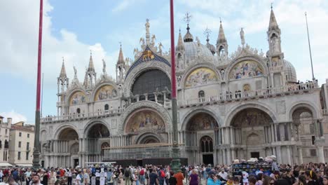 walking through a busy crowd of tourists visiting saint mark's basilica at venice in italy.