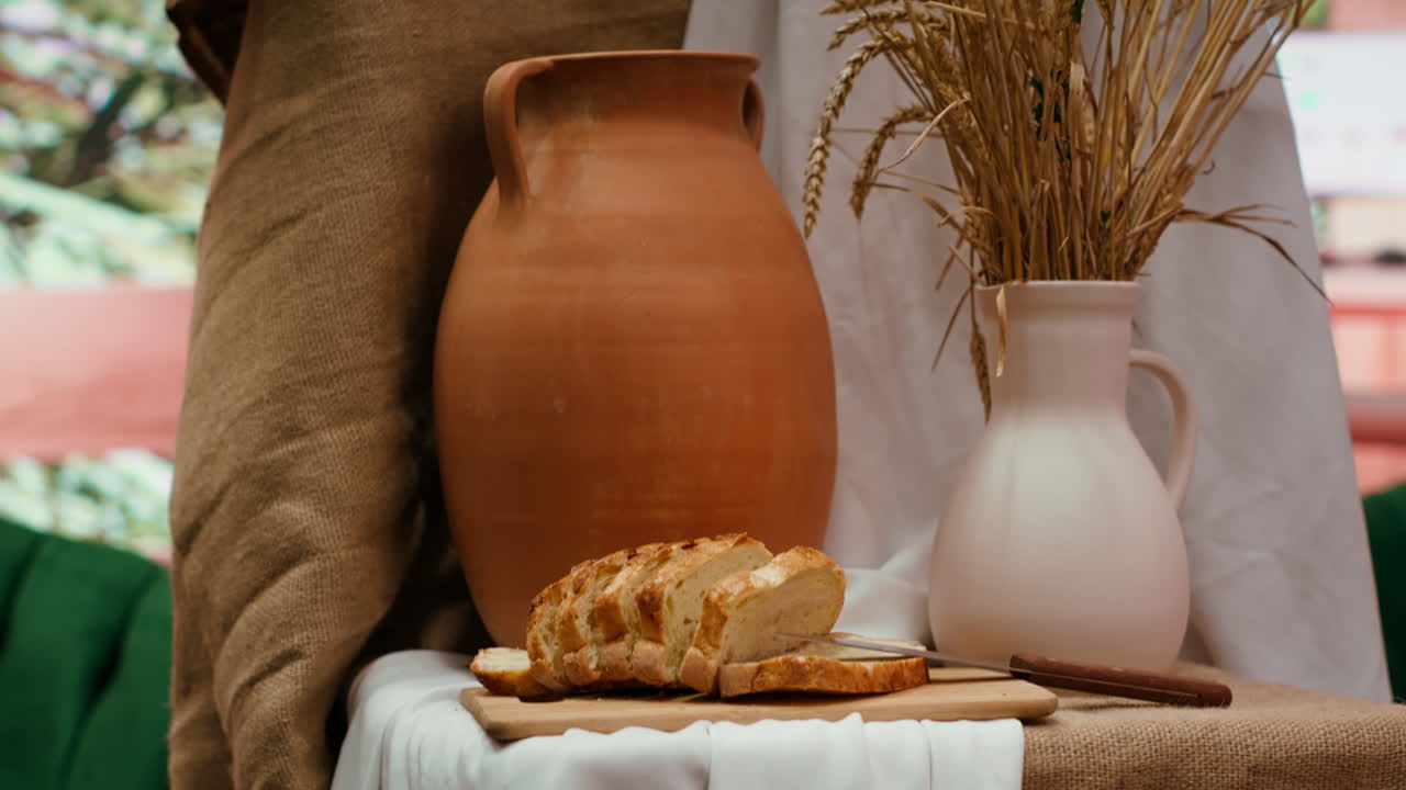 Still life with bread, pitchers, and wheat