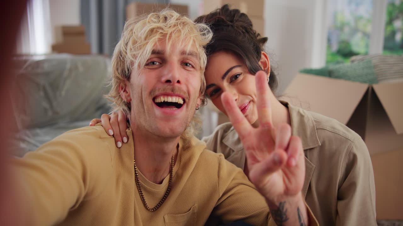 Happy Young Couple Takes Selfie with New House Keys in Their New Home