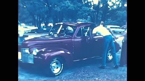 classic red-seated car at 1970s american old car show. circa usa - 1970s: a photograph capturing a vintage car with a distinctive red seat, showcased at an old car event during the 1970s in the united states.