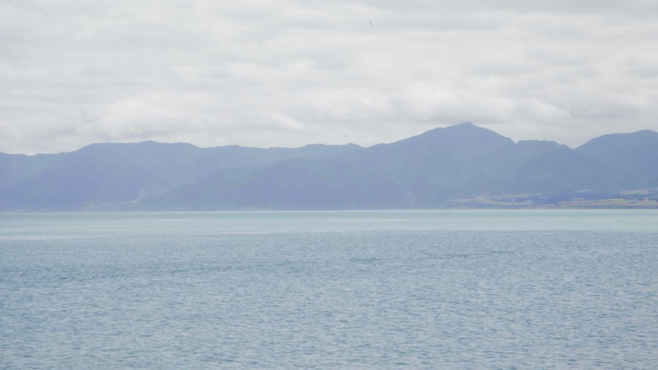 Serene Ocean Landscape with Distant Mountains