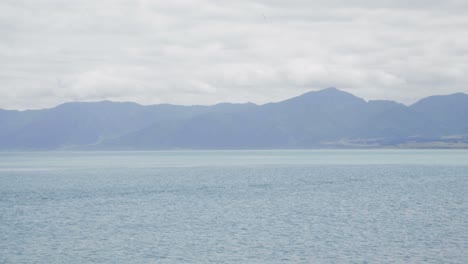 serene ocean landscape with distant mountains