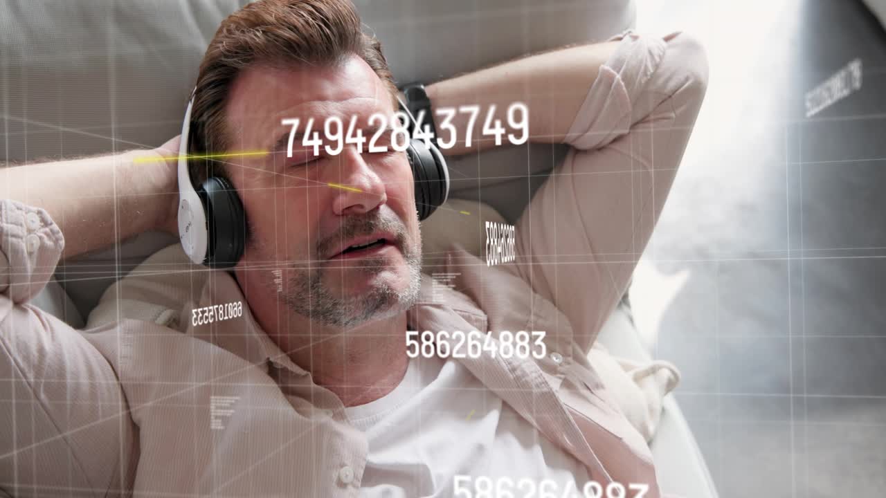Mature man resting on sofa wearing headset as music playing faint tech HUD drifting showing metrics