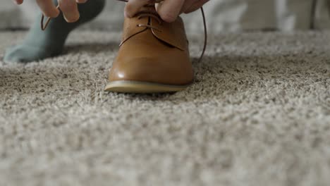 groom tying his shoes