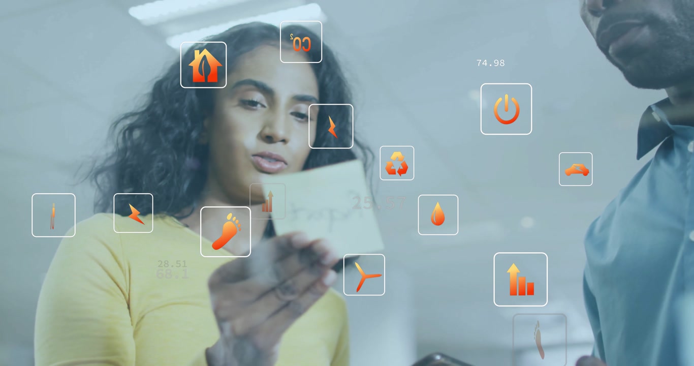 woman lifting card rotating while man holding tablet, generating AR icons displaying metrics