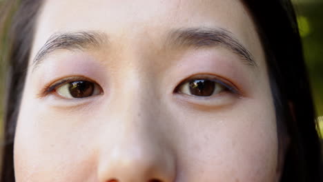 close-up of woman with closed eyes, relaxing and meditating outdoors