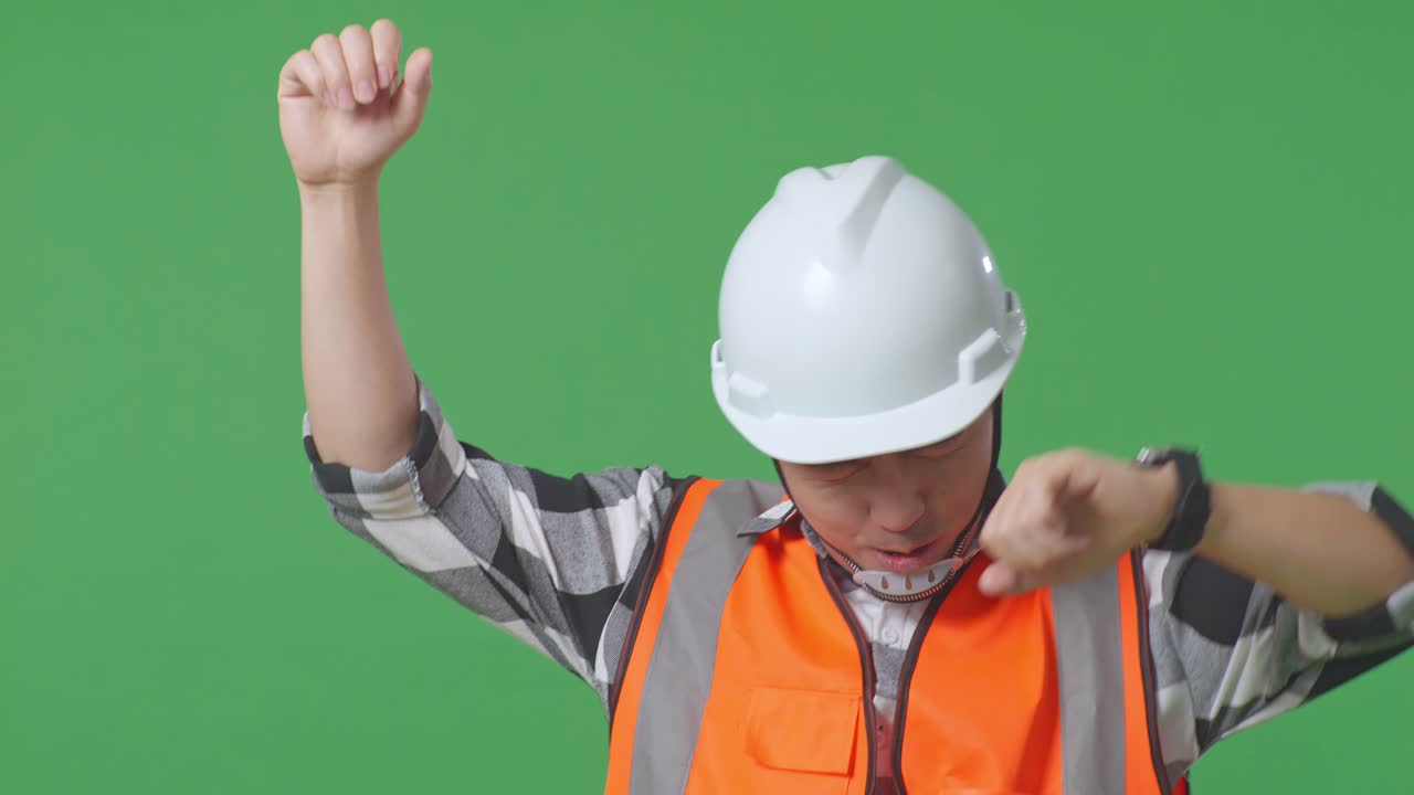 Close Up Of Asian Male Engineer With Safety Helmet Screaming Goal And Dancing Celebrating In The Green Screen Background Studio