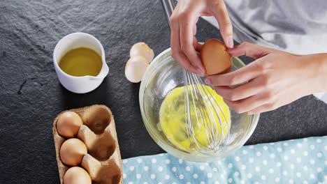 woman breaking eggs into a bowl 4k