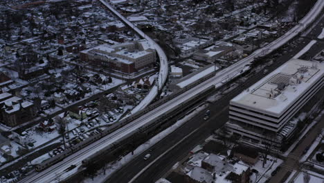 An-aerial-shot-in-the-suburbs-next-to-an-industrial-area-with-train-tracks-and-a-highway