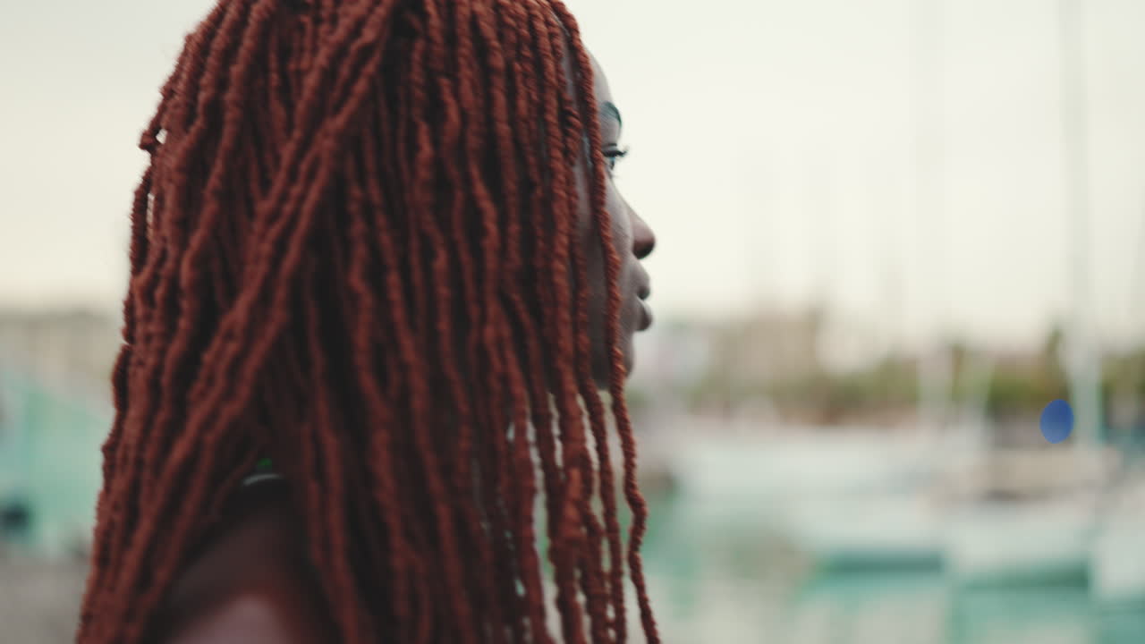Ritratto di una donna di colore con dreadlock rossi