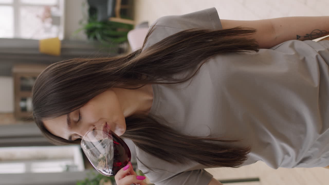 Vertical Portrait of Young Woman Toasting with Red Wine