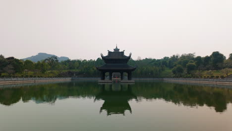 reflections on the pond at bai dinh pagoda buddhist temples in ninh binh province, vietnam. wide shot