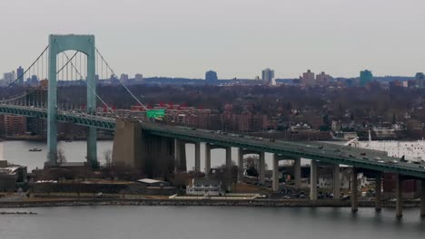 an aerial view of the throgs neck bridge from over the long island sound, ny on a cloudy day