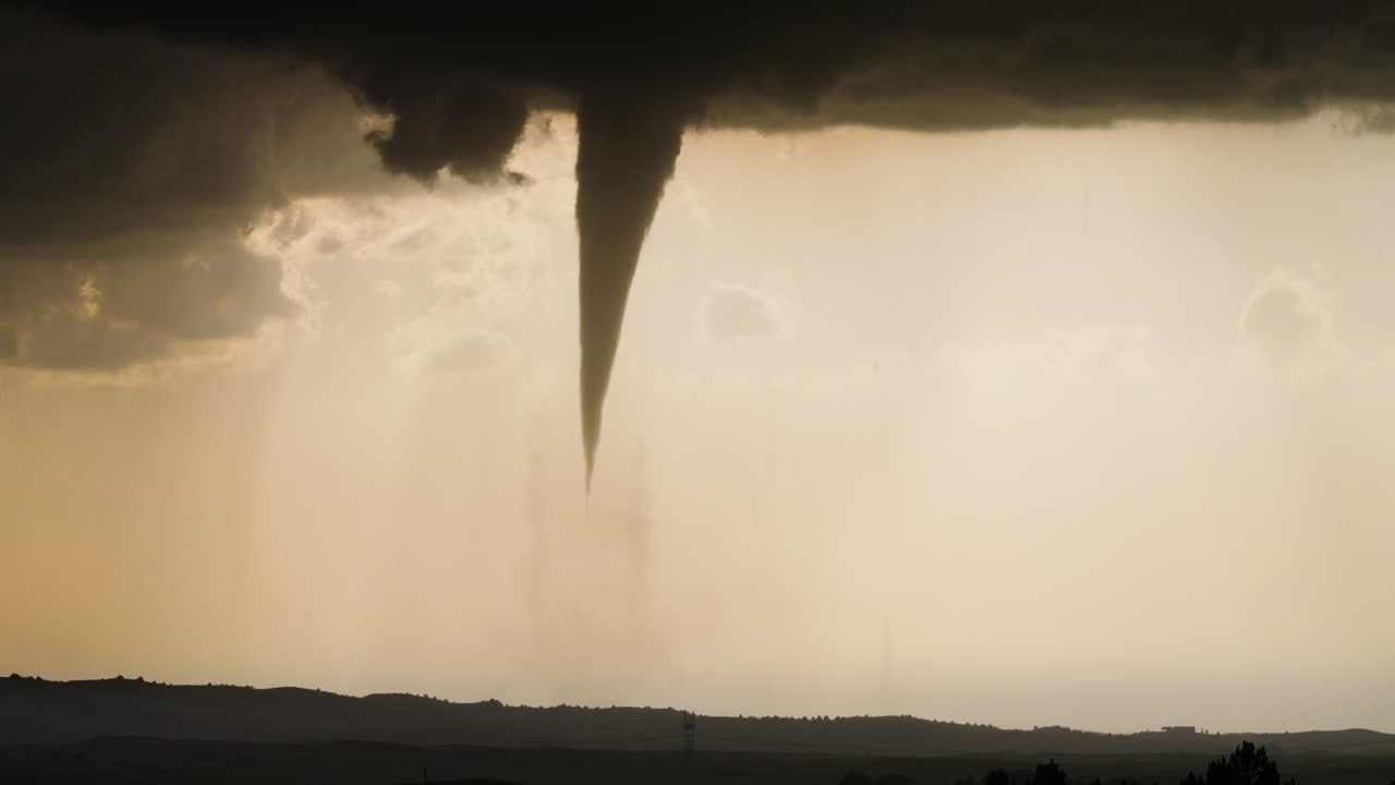 Tornado Funnel Cloud Spinning Across Fields Under Severe Storm Skies