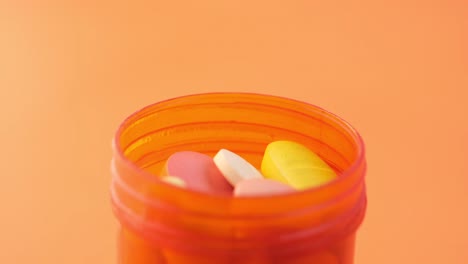 orange pill bottle with assorted medications