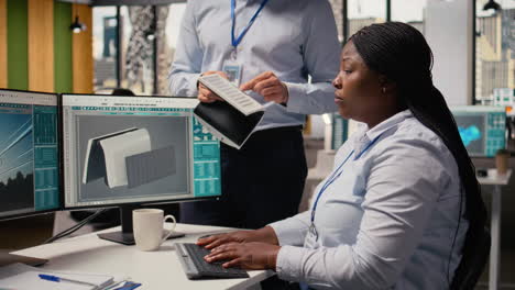 employees talking, evaluating solar cell technology alternative energy device