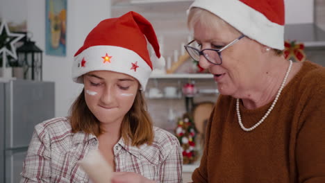 Grandmother-teaching-granddaughter-how-sift-flour-ingredient-preparing-homemade-delicious-dessert