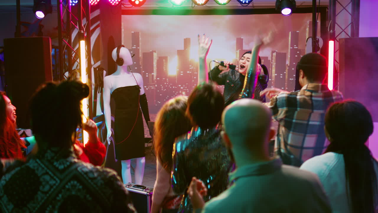 DJ performs in a nightclub with a crowd of people