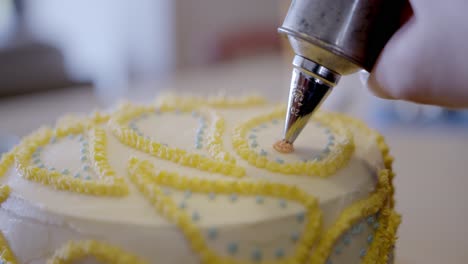 Cake-decoration-in-close-up,-pink-blue-and-yellow-icing