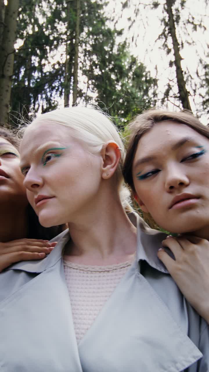 Fashionable women posing in a forest