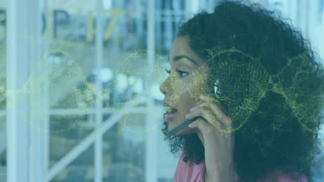 customer service agent speaking into phone headset in office, showing digital network overlay