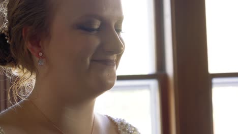 tilting reveal of young bride as she happily nods at the camera