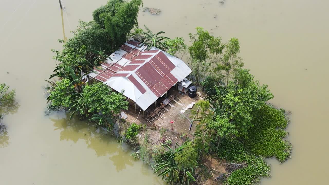 A Rural House is Surrounded by Floodwaters in Sylhet, Bangladesh, South Asia - Orbit Drone Shot