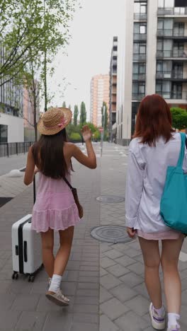 two young women traveling in city