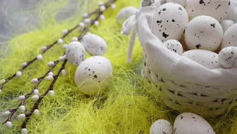 easter white dotted eggs in the nest and spring yellow grass