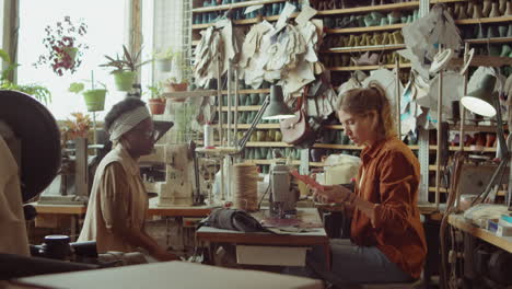 female coworkers discussing shoe patterns in workshop