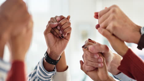 team hands together in celebration