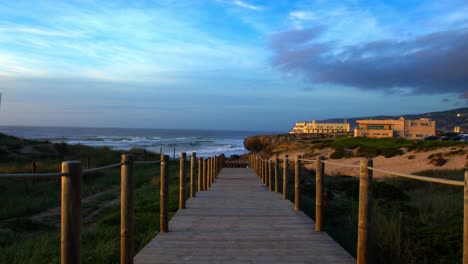 guincho beach wooden path portugal cascais sintra during golden hour sunset big waves vacation wide shot no people