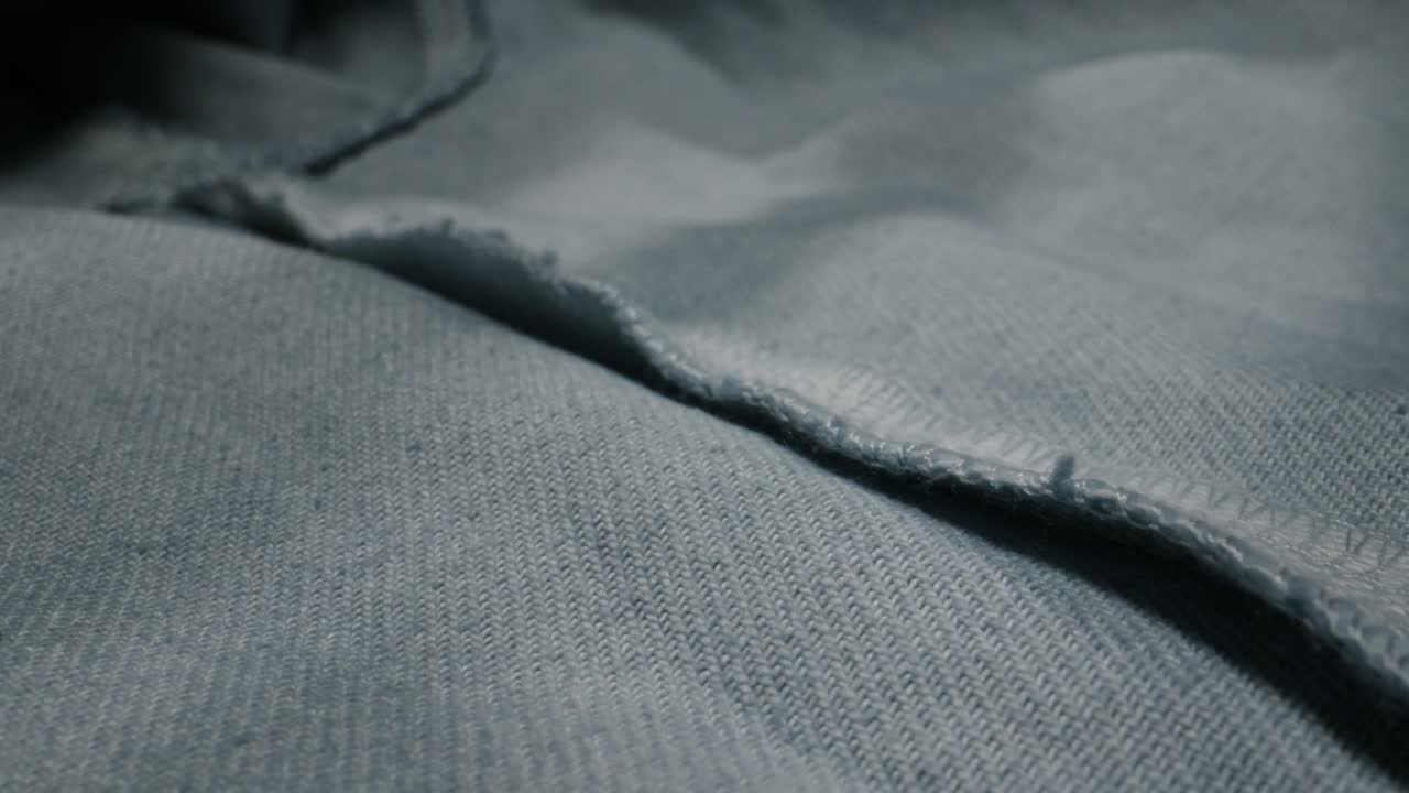 Close-up view of a gray fabric with a raw edge