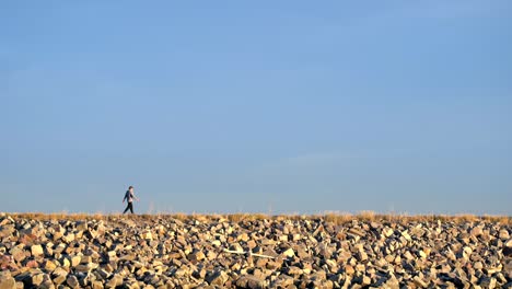 Man-walking-in-a-trail-along-the-Boulder-Reservoir,-Colorado