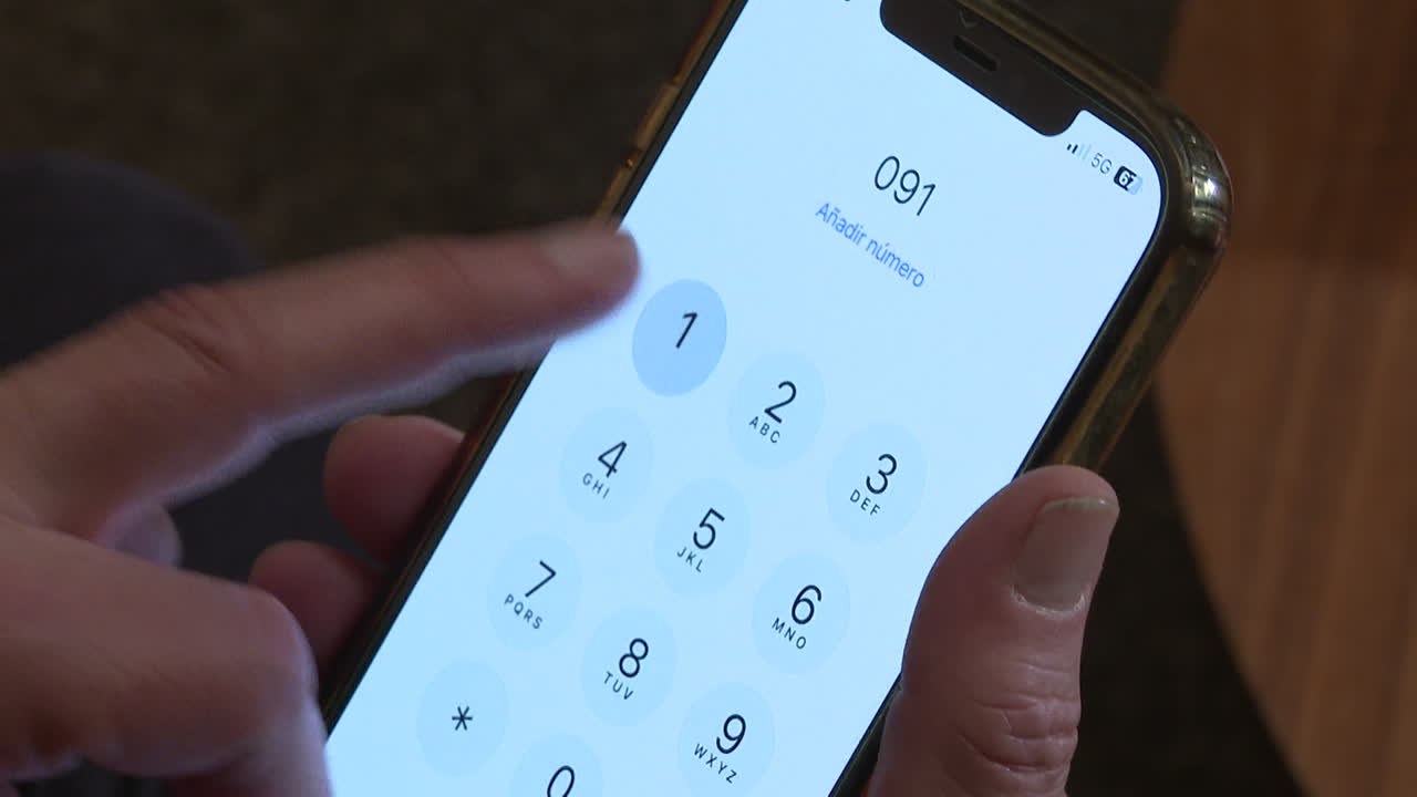 Person dialing a phone number on a smartphone