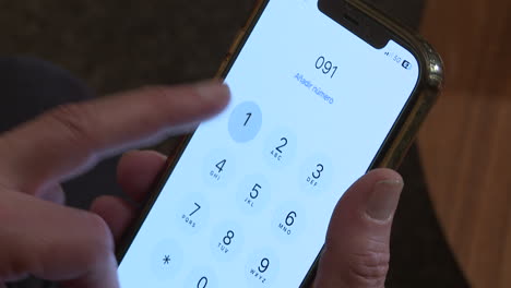 Person dialing a phone number on a smartphone