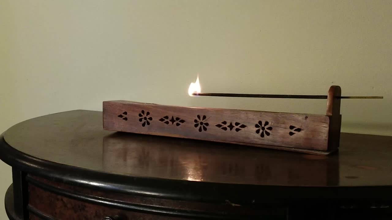 Man Prepares Incense Burner in Closeup