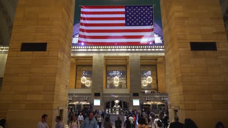 Wide shot of commuters rushing through the Main Concourse during peak hours